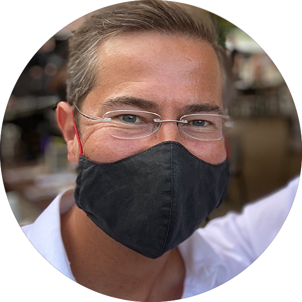 A portrait photo of Stefan Gentz with community face mask, 2020.
